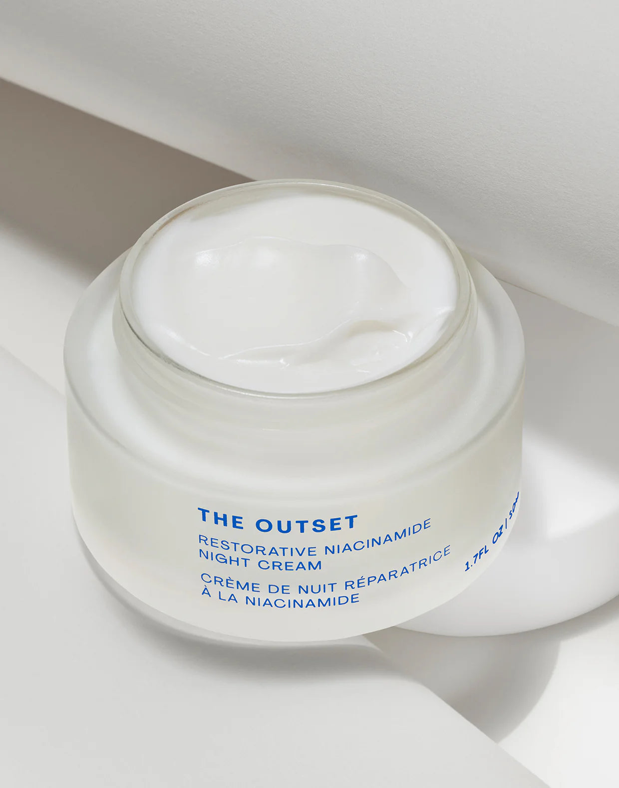 Restorative Niacinamide Night Cream in a glass jar with a creamy texture, designed for overnight skin rejuvenation.