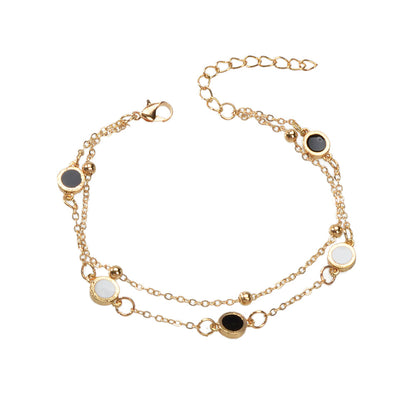 Round Disc Double Layer Bracelet featuring gold chains and elegant black and white disc accents.