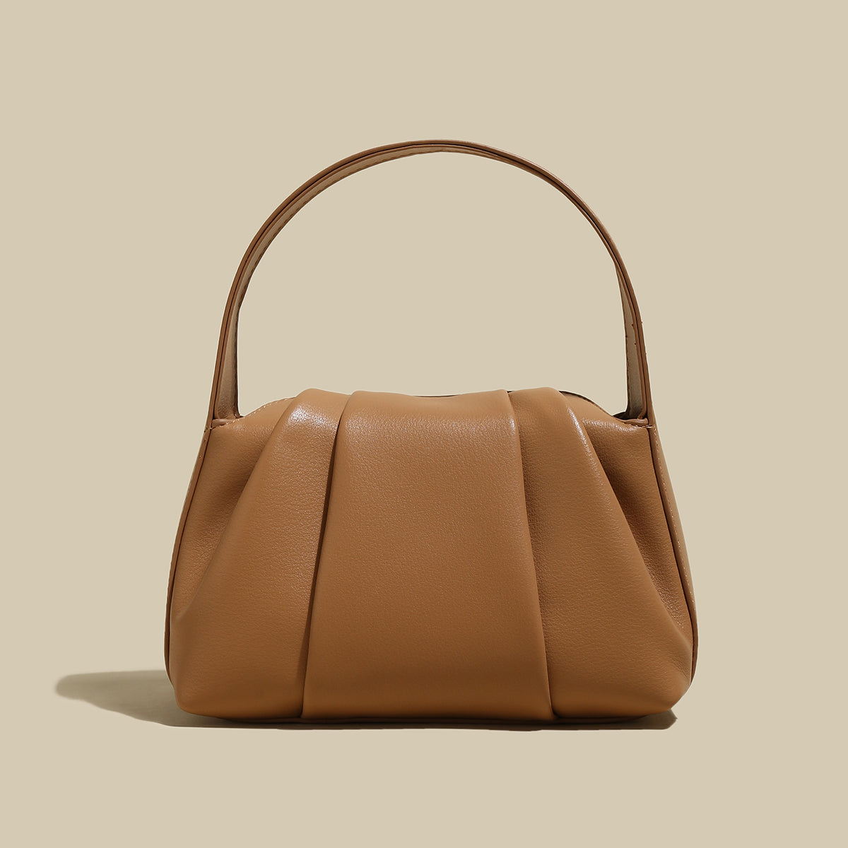 Ruched Leather Handbag featuring elegant pleats and spacious design, perfect for day-to-night transitions.